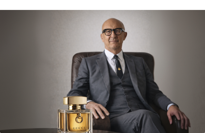 Marco Bizzarri, former president and CEO of Gucci, with a Gucci fragrance bottle.